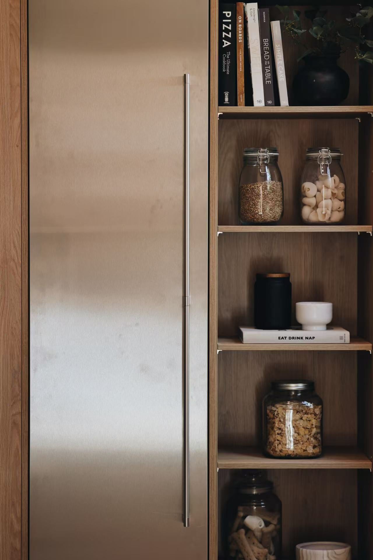 Vertical built-in display shelf with ceramics and books