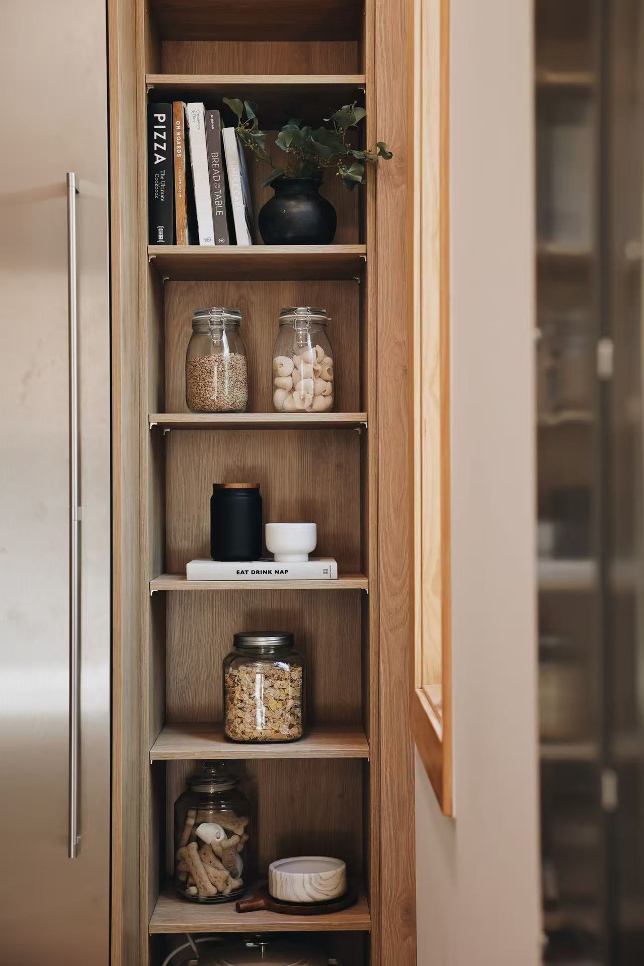 Close view of timber display shelf and tall storage panel