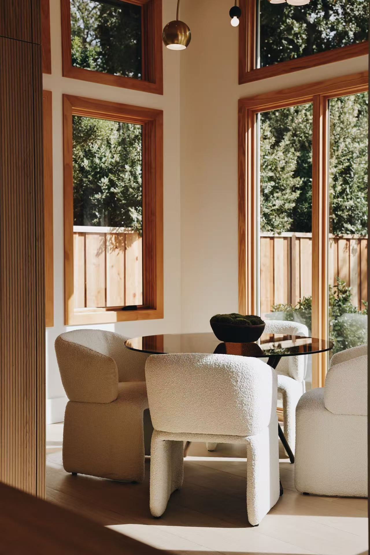 Small seating area with armchair, timber windows, and side table