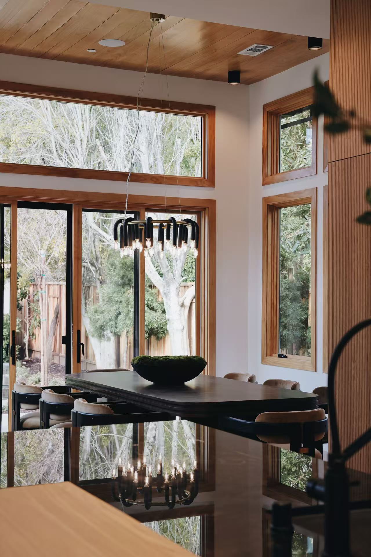 Window-side seating vignette with dark chair and timber trim