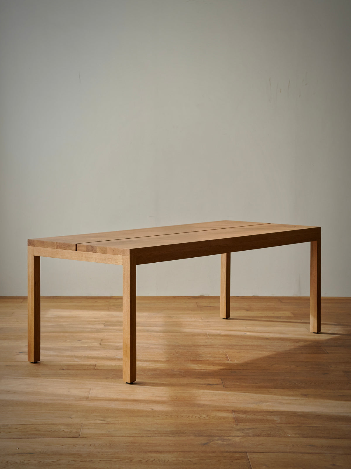 Flora Crest Dining Table in a finished interior.