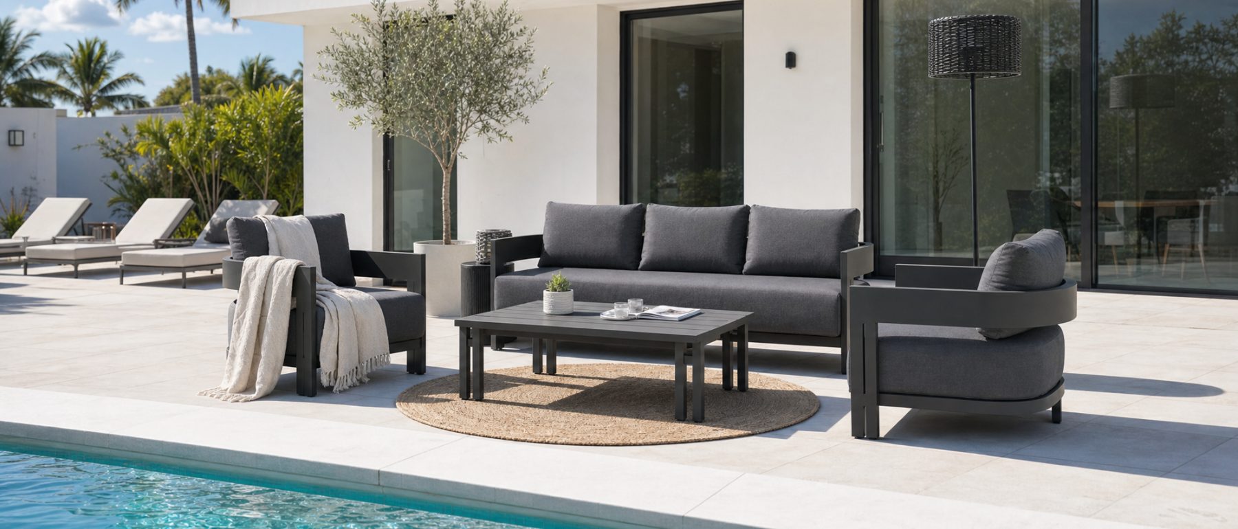 Charcoal aluminium sofa set beside a pool