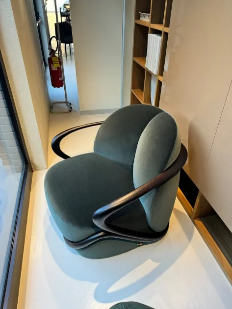Pink lounge chair reviewed in showroom setting