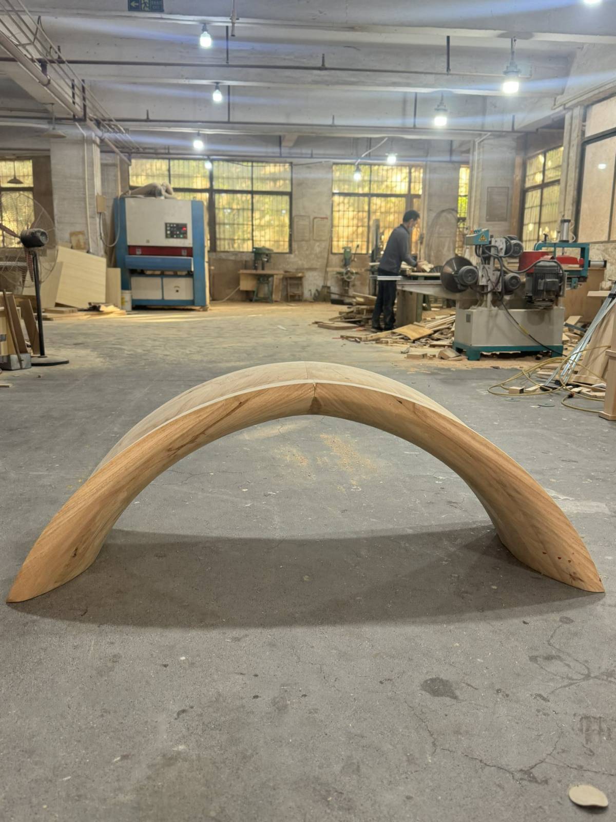 Curved wood structure reviewed during custom furniture production