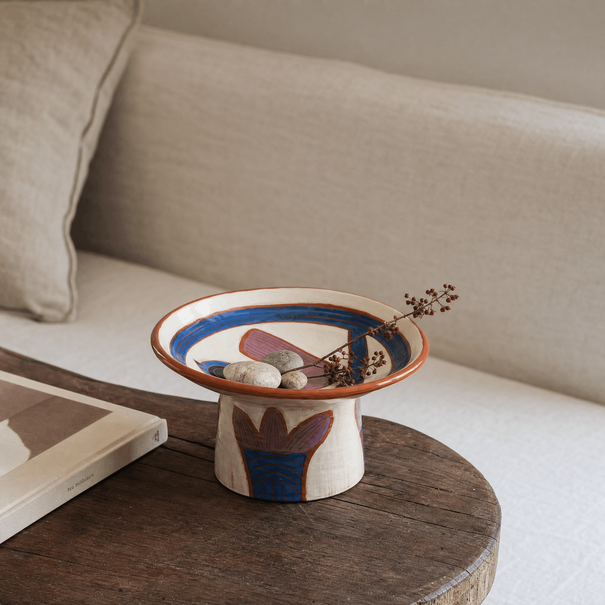 Hand Painted Bird Pedestal Bowl in a finished interior.