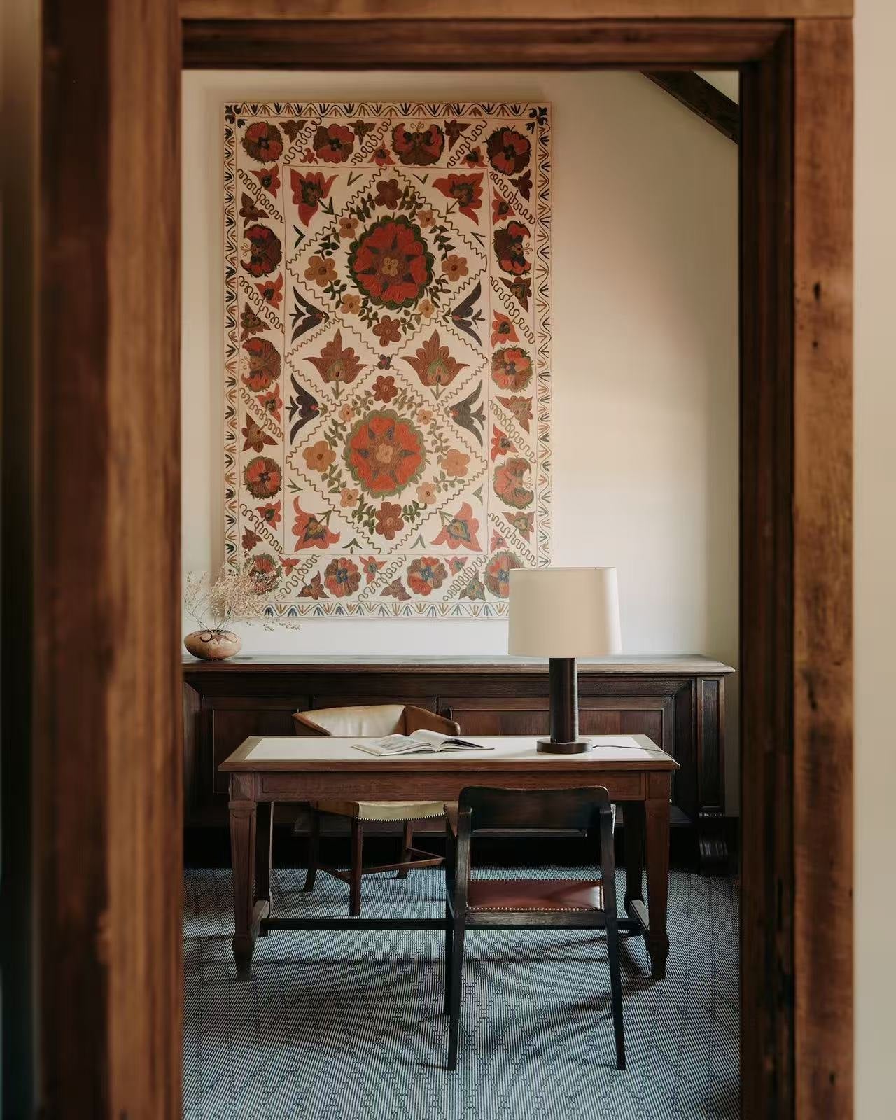 Console table with framed art in a quiet vignette