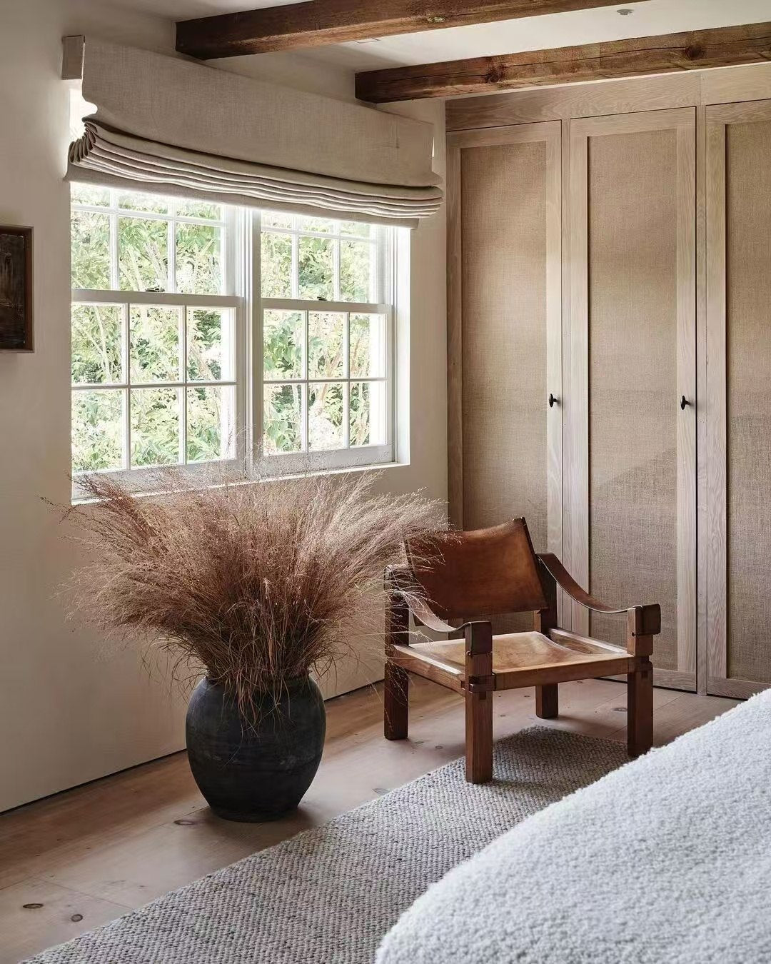 Warm reading corner with an armchair and timber walls