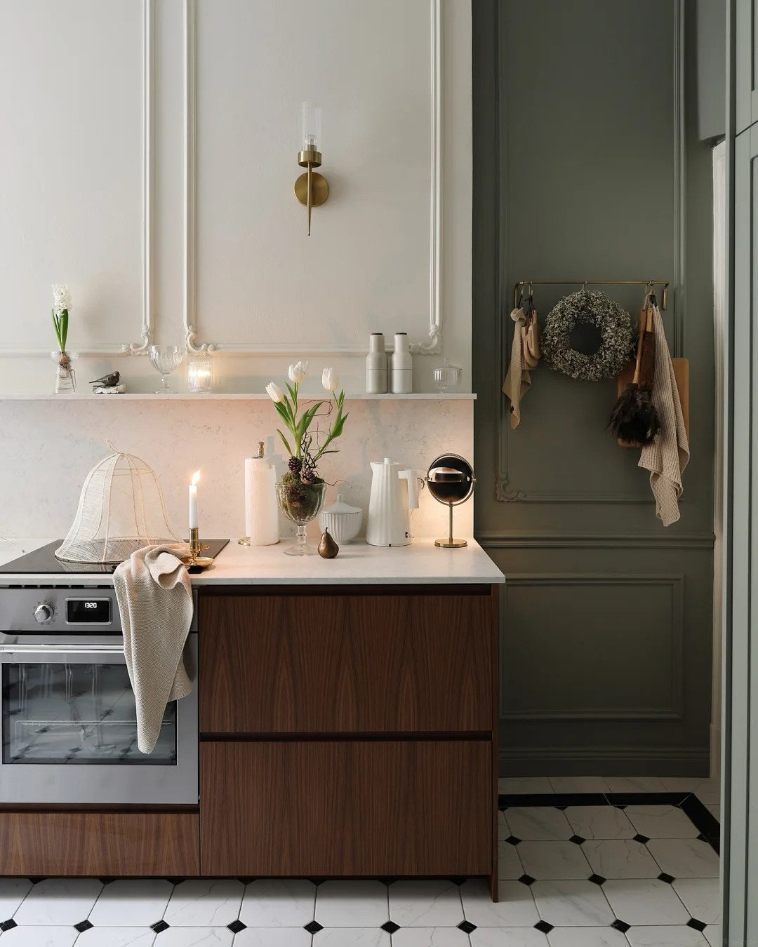 Let tall painted storage add depth beside wood cabinets