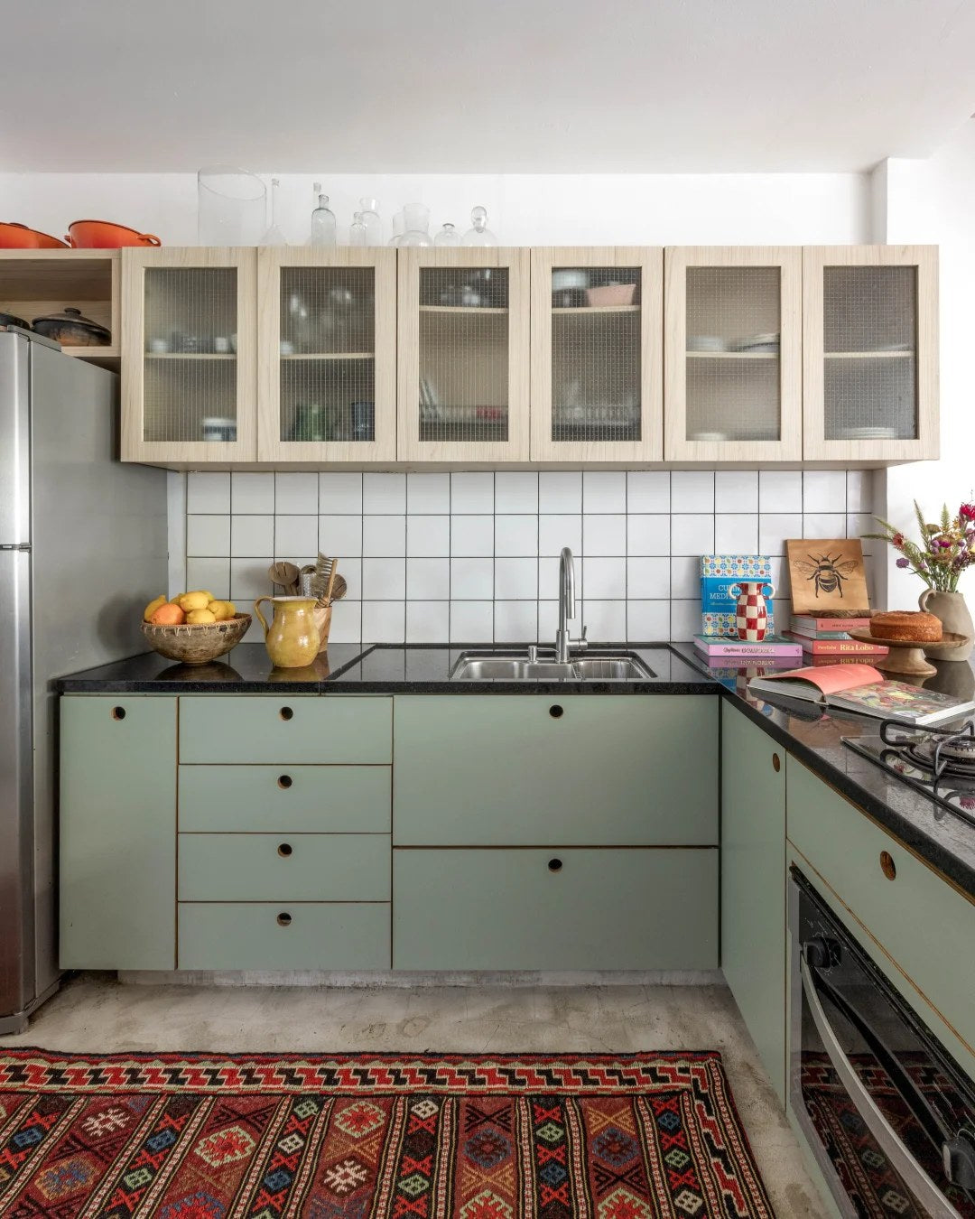 Muted green cabinets work beautifully with natural texture