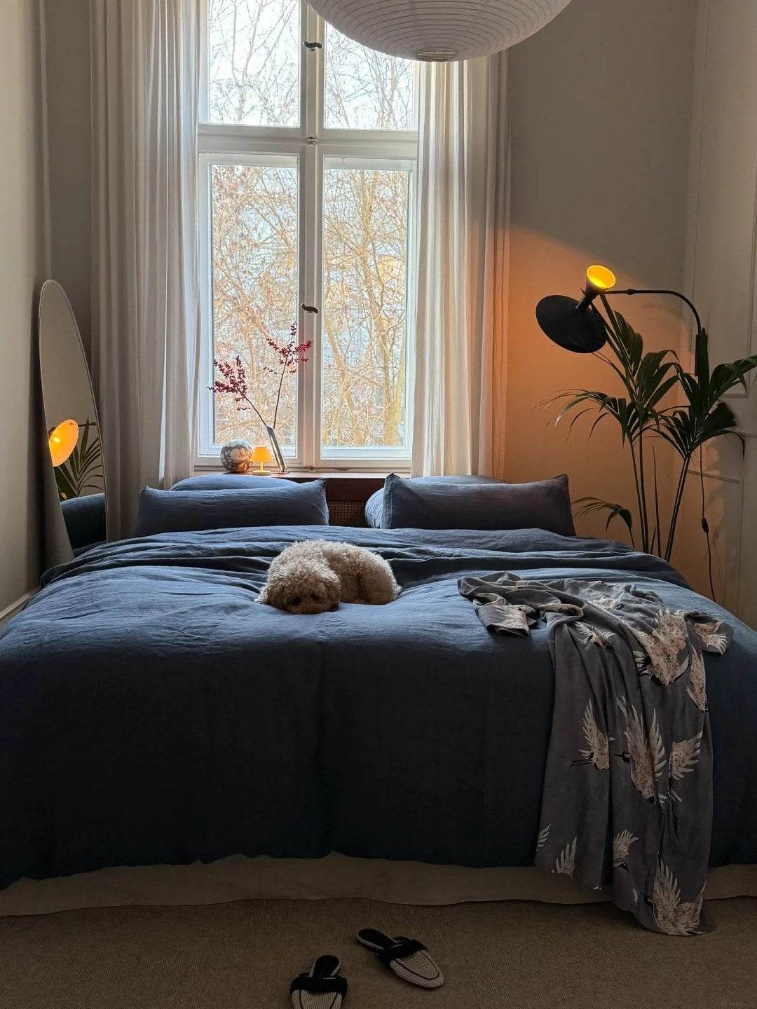 Let deep bedding color anchor a calm storage plan