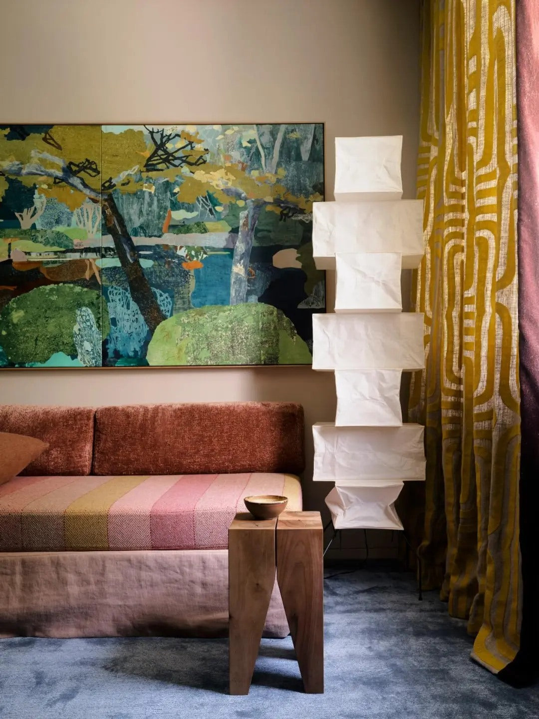 A bold art wall gives the seating area a strong emotional center.