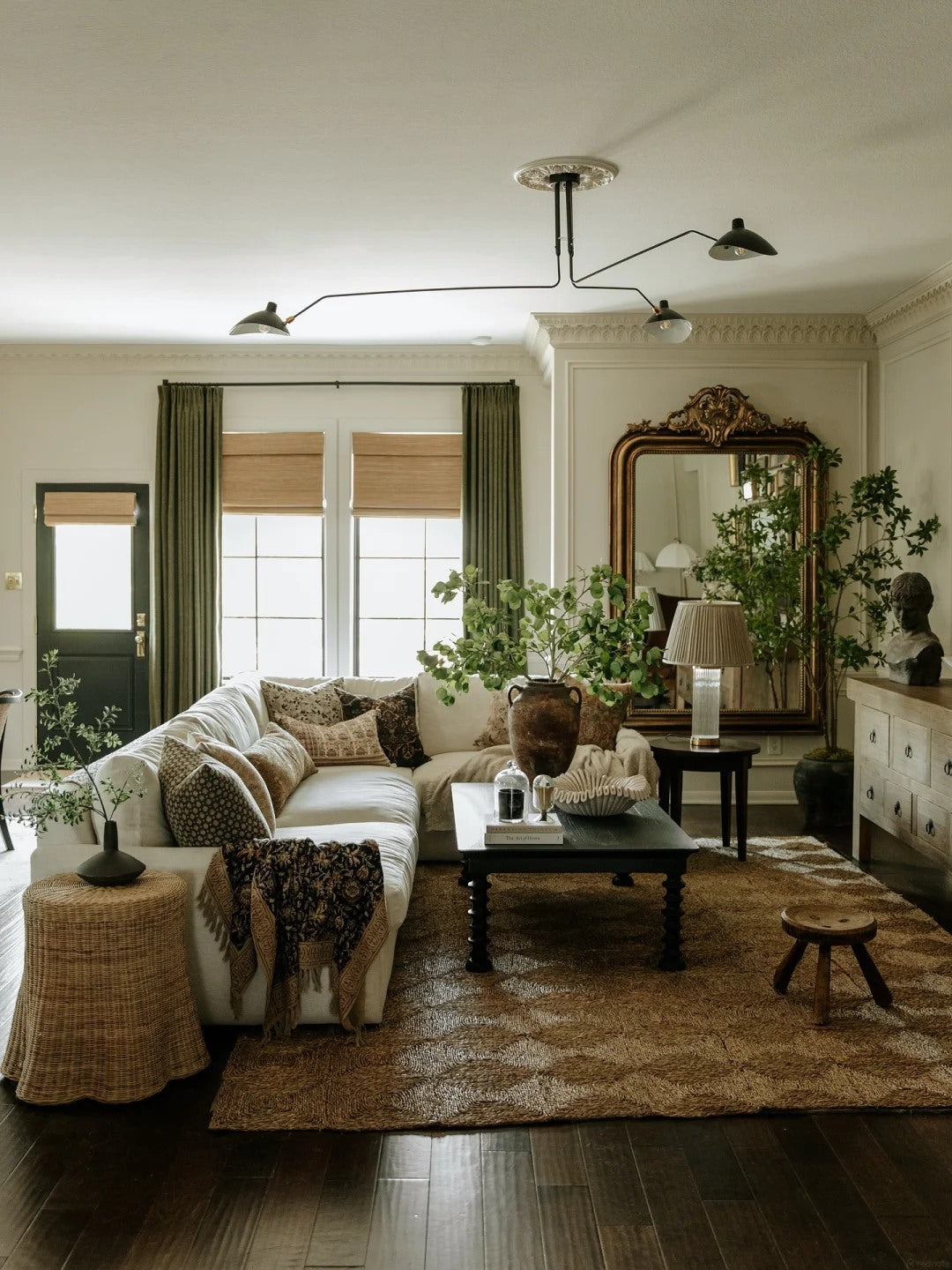 Layered artwork creates depth above a sofa without needing heavy furniture.