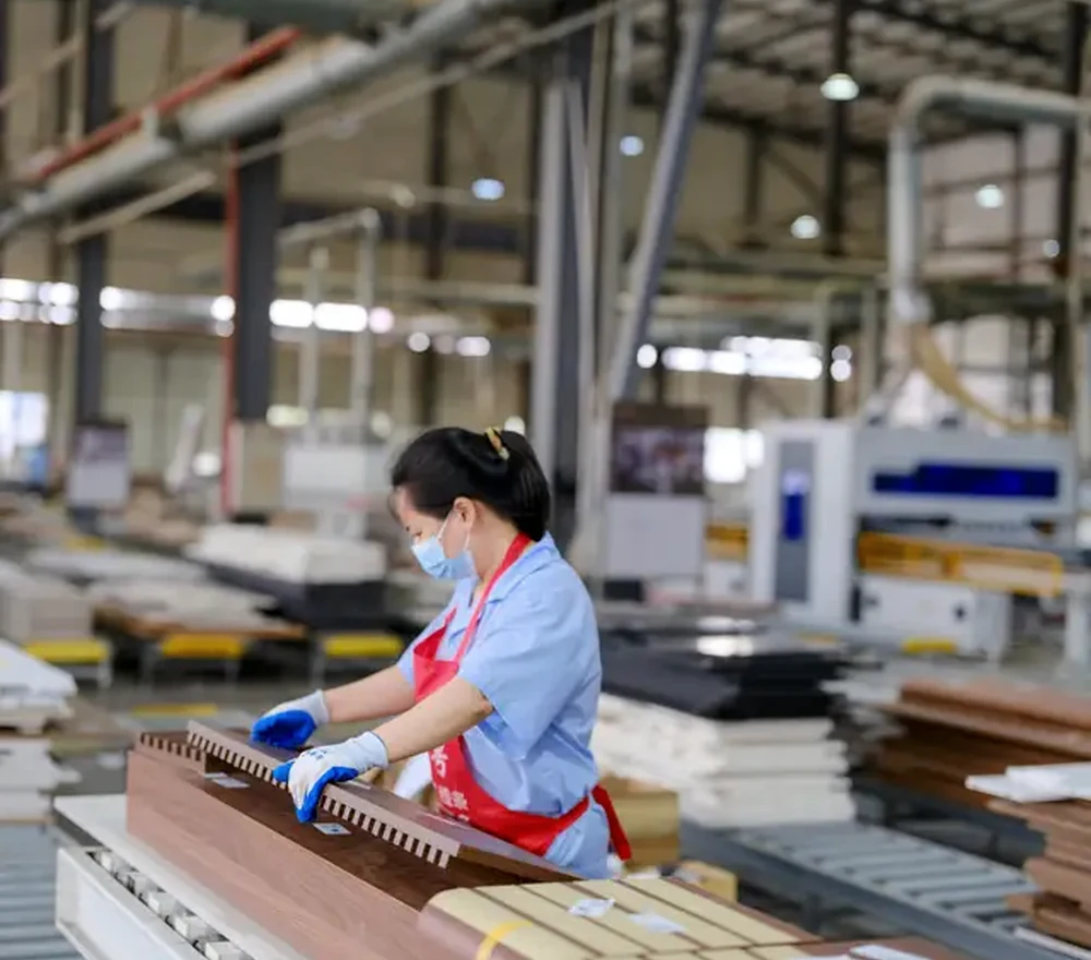 Factory worker inspecting finished timber components on the production line