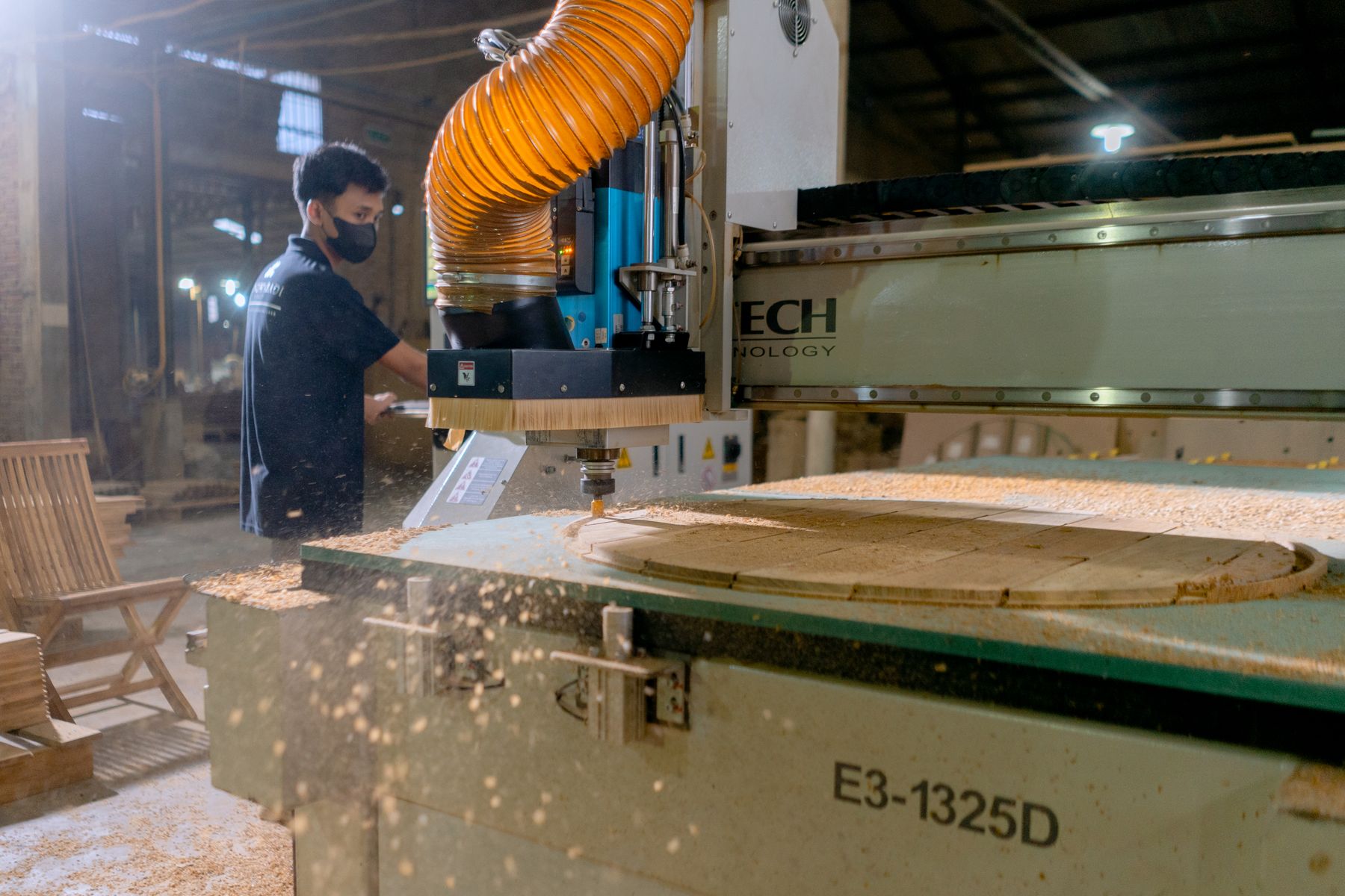 Woodworking CNC machine cutting a timber component on a factory floor