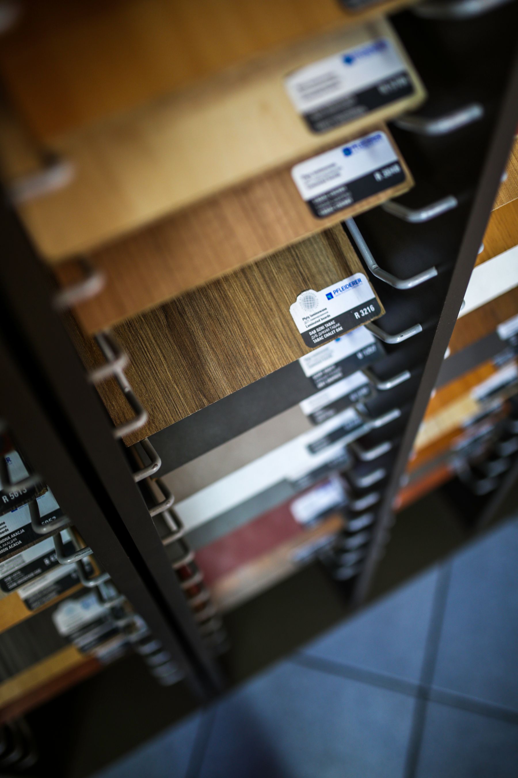 Display rack of laminated wood samples showing different colours, grains and surface finishes