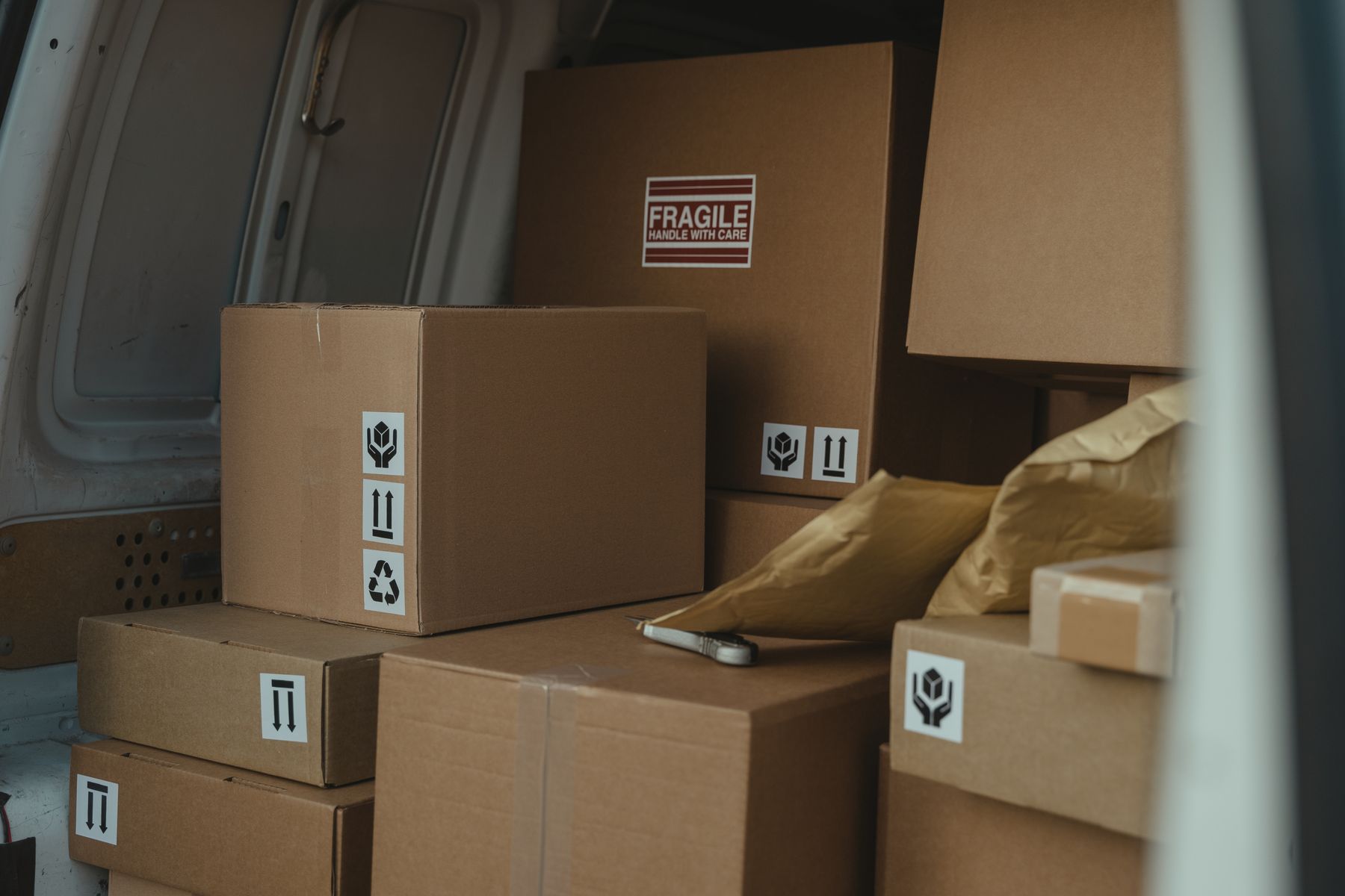 Sealed cardboard packages with handling labels inside a delivery vehicle