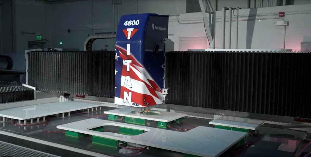 CNC stone fabrication equipment shaping countertop pieces and sink openings