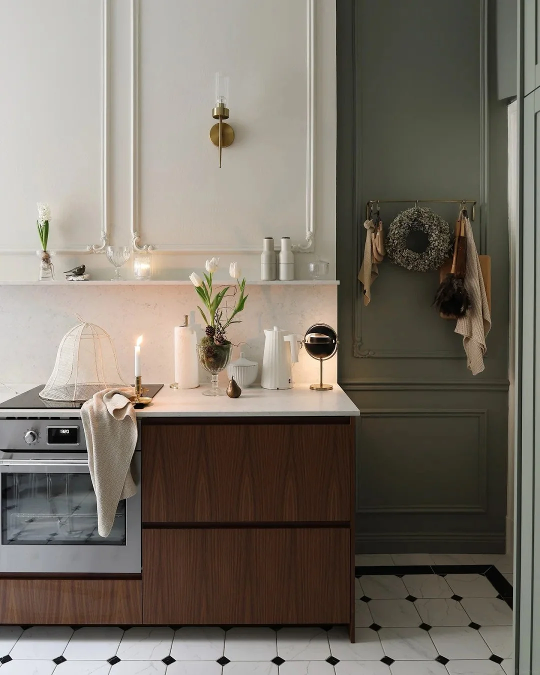 Let tall painted storage add depth beside wood cabinets