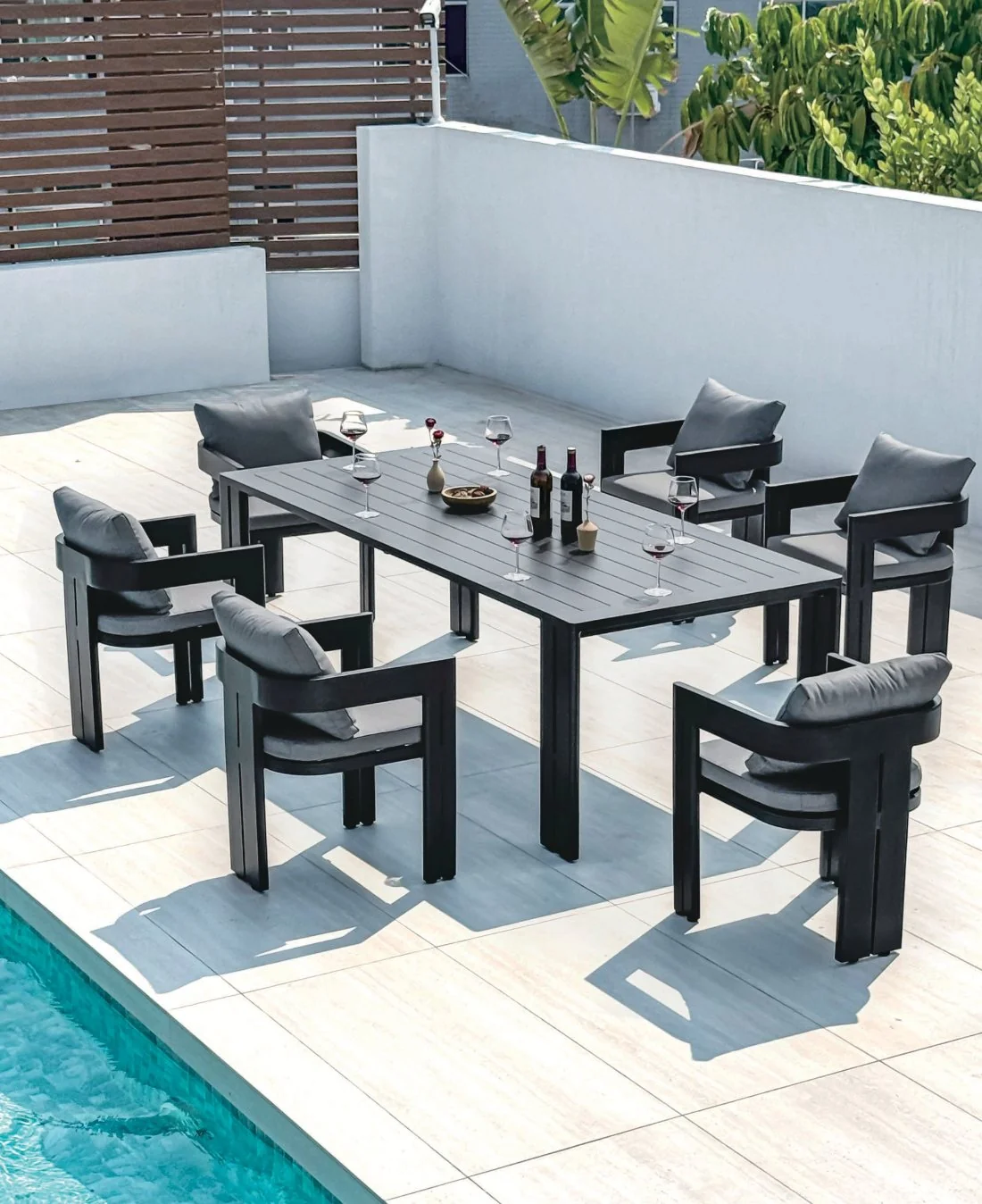 Stone-top table and black outdoor dining chairs