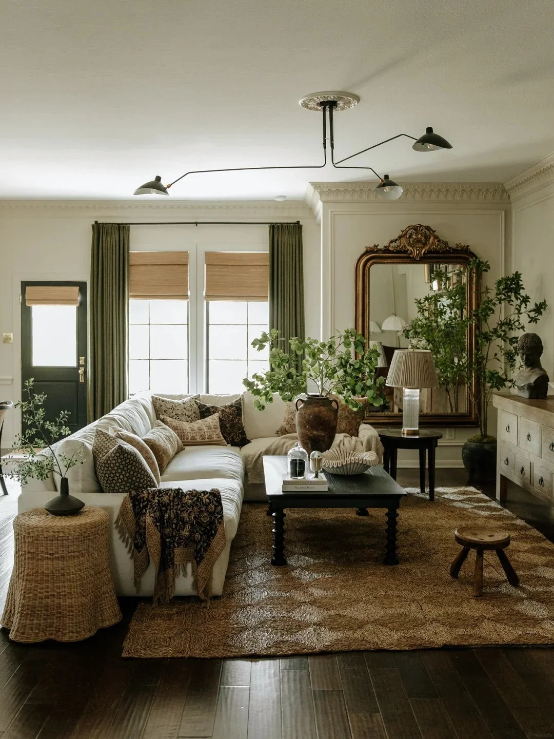 Layered artwork creates depth above a sofa without needing heavy furniture.