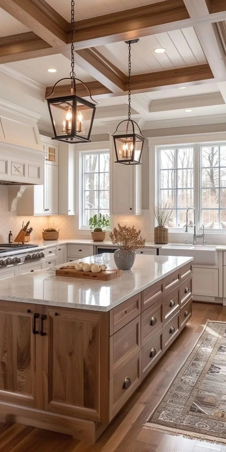 Warm white perimeter cabinets feel more layered when paired with a wood island and warm lighting.