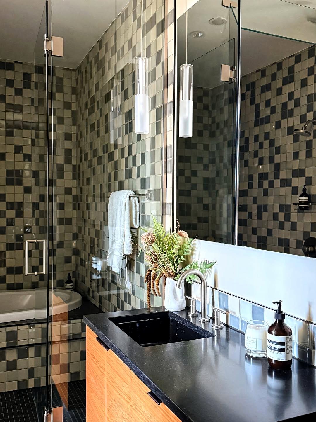 Bathroom with patterned tile and warm vanity