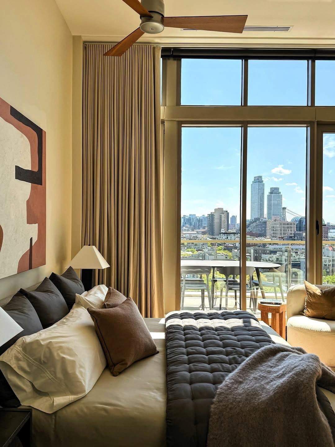 Warm bedroom with city skyline view