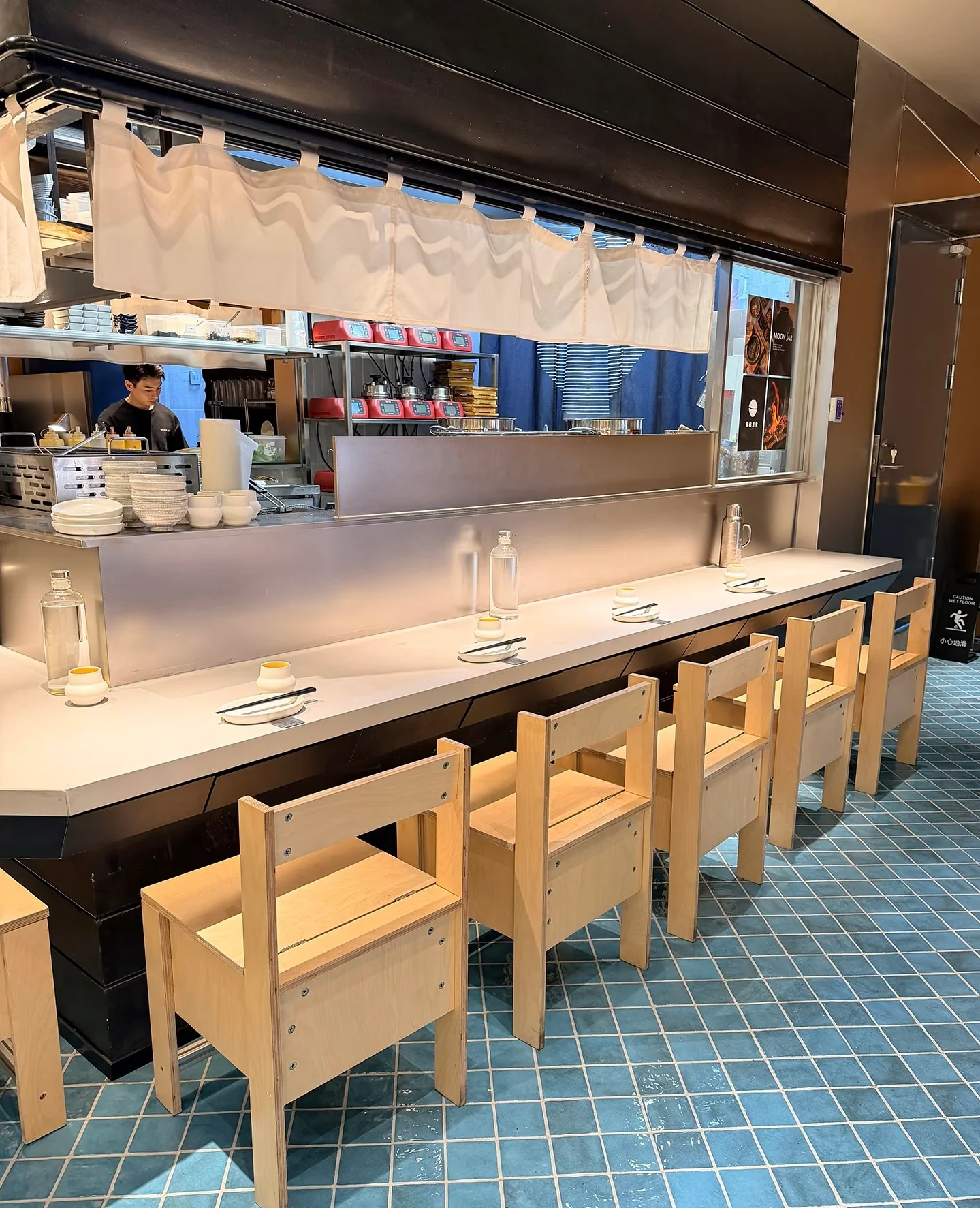 Timber counter-height chairs arranged along a restaurant dining counter