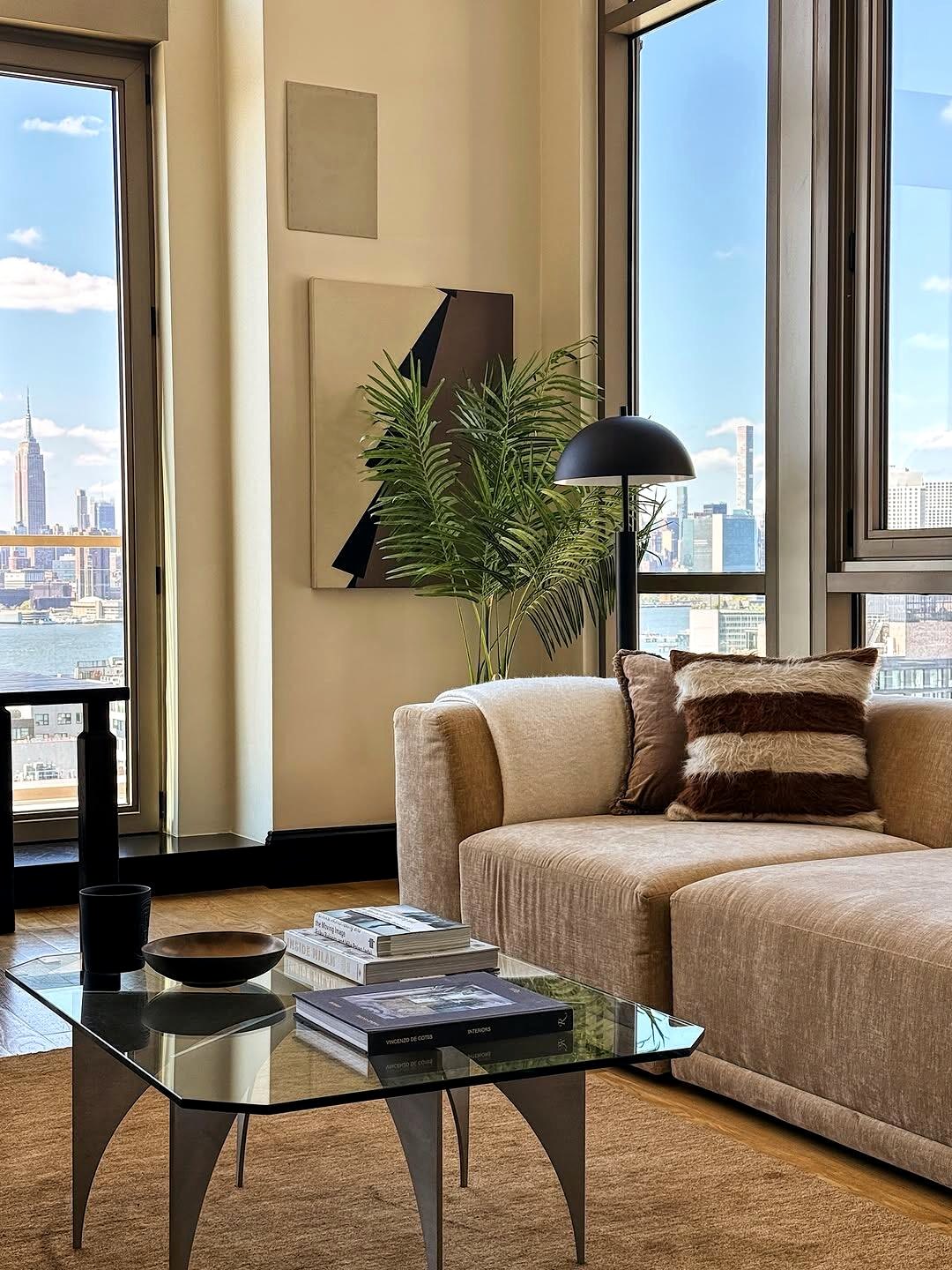Warm neutral living room sofa and glass coffee table