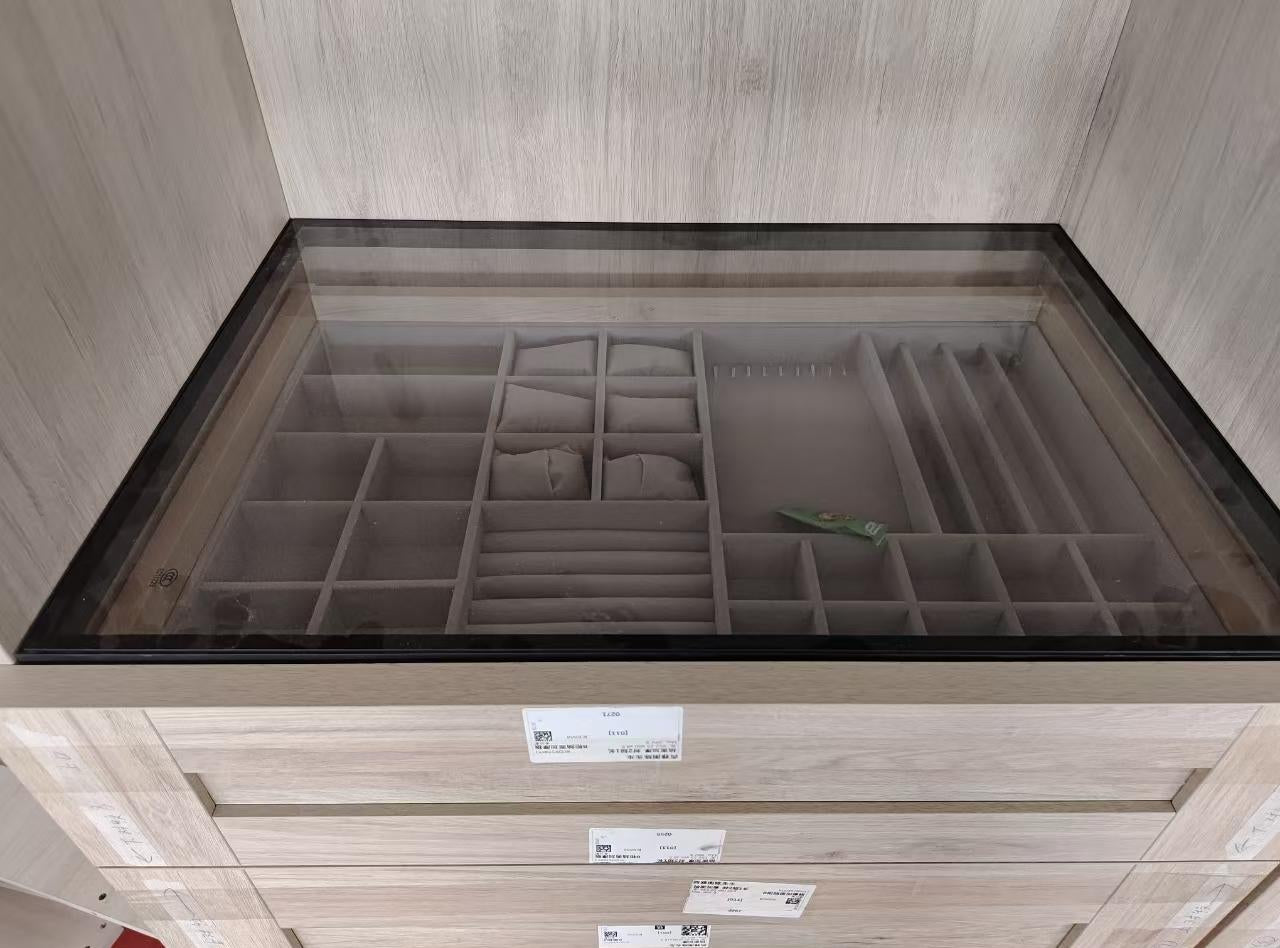 Protective film still on a glass drawer top during inspection