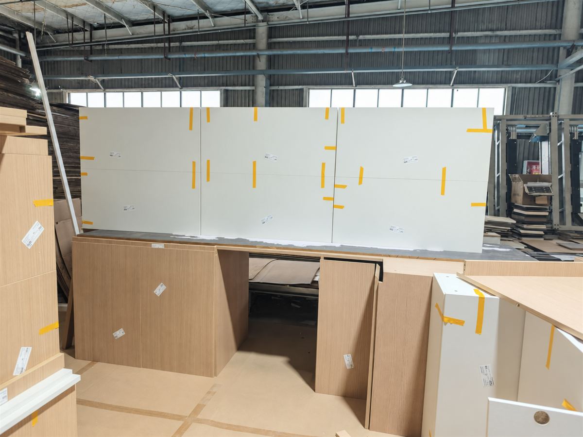 Cream white door panels laid out across the assembled base run