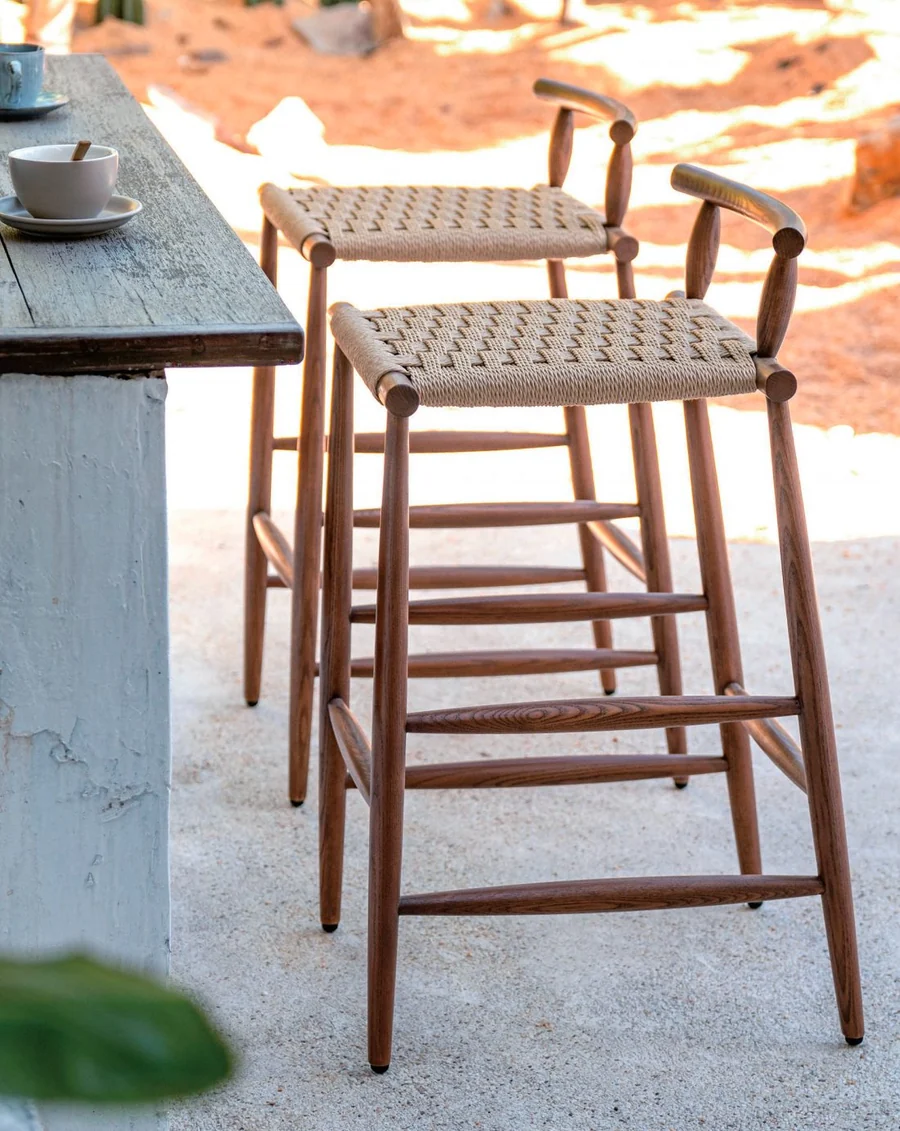 Pair of woven-cord counter stools at an outdoor bar