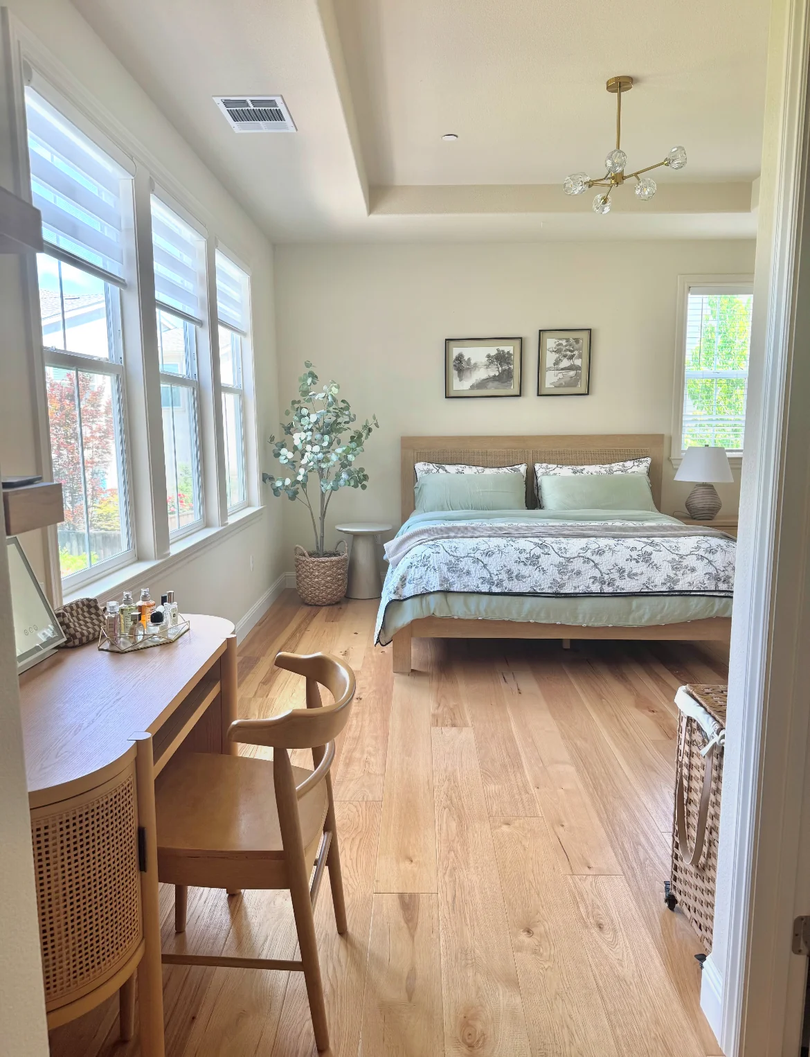 Bright bedroom with a timber bed, cane headboard, matching desk, chair and bedside furniture