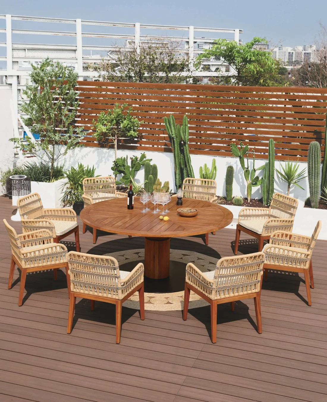 Round teak dining table with six woven chairs