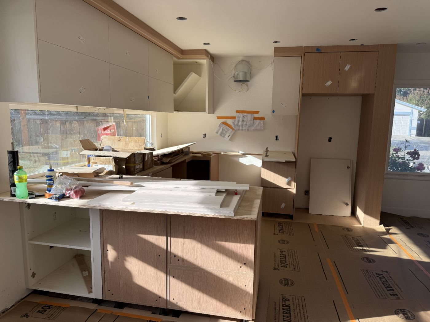 Sink run and peninsula with door panels staged on the counter