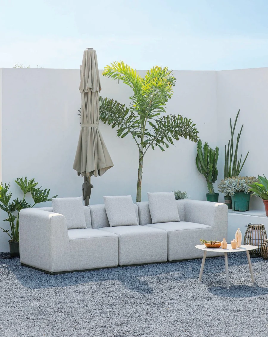 Grey modular outdoor sofa on a courtyard terrace