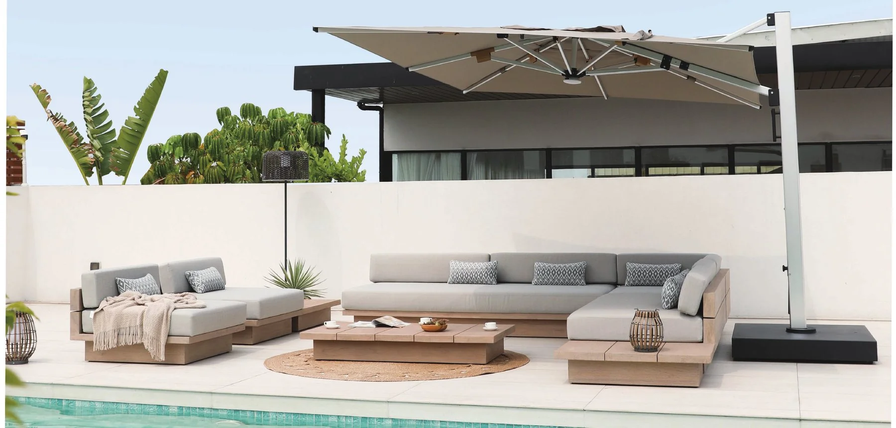 Outdoor sofa and table arrangement beside a swimming pool