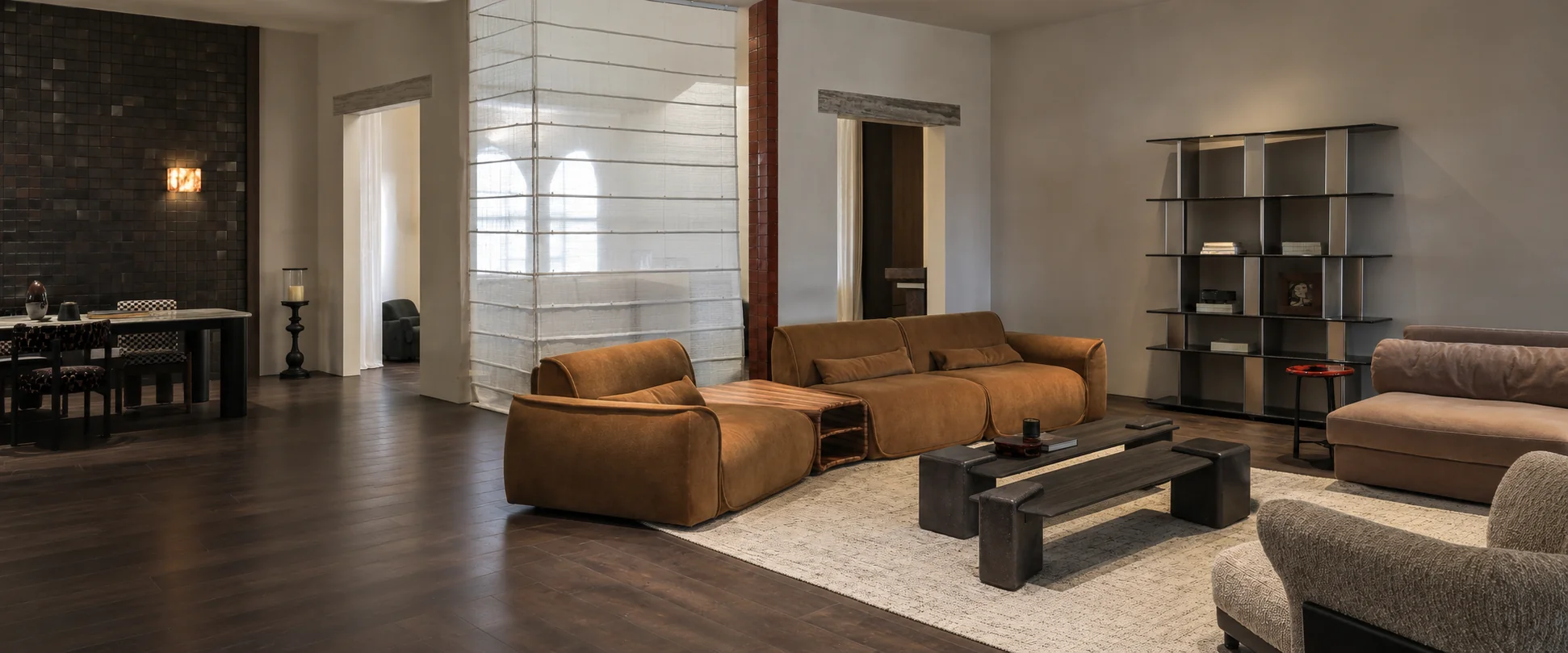 AI-assisted panoramic composite of the supplied furniture showroom photographs, with cognac lounge seating, dark coffee tables and open shelving