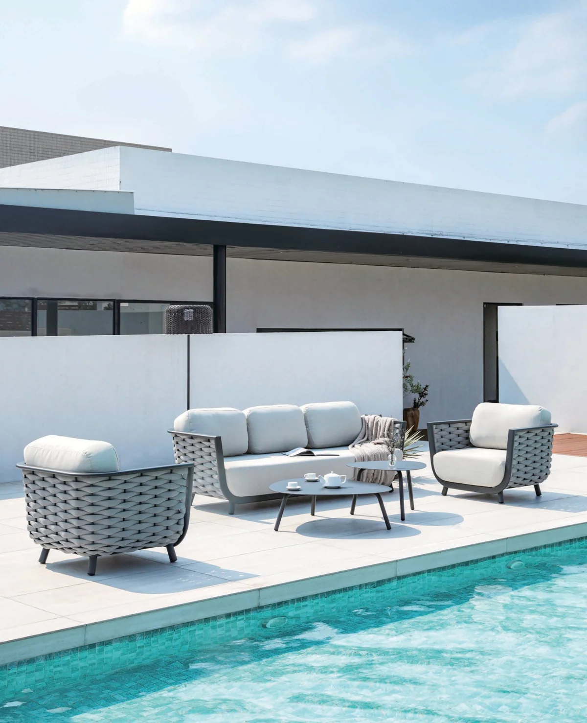 Rope sofa and chairs beside a swimming pool