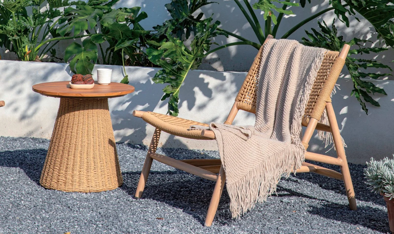 Rope lounge chair and side table on a gravel terrace