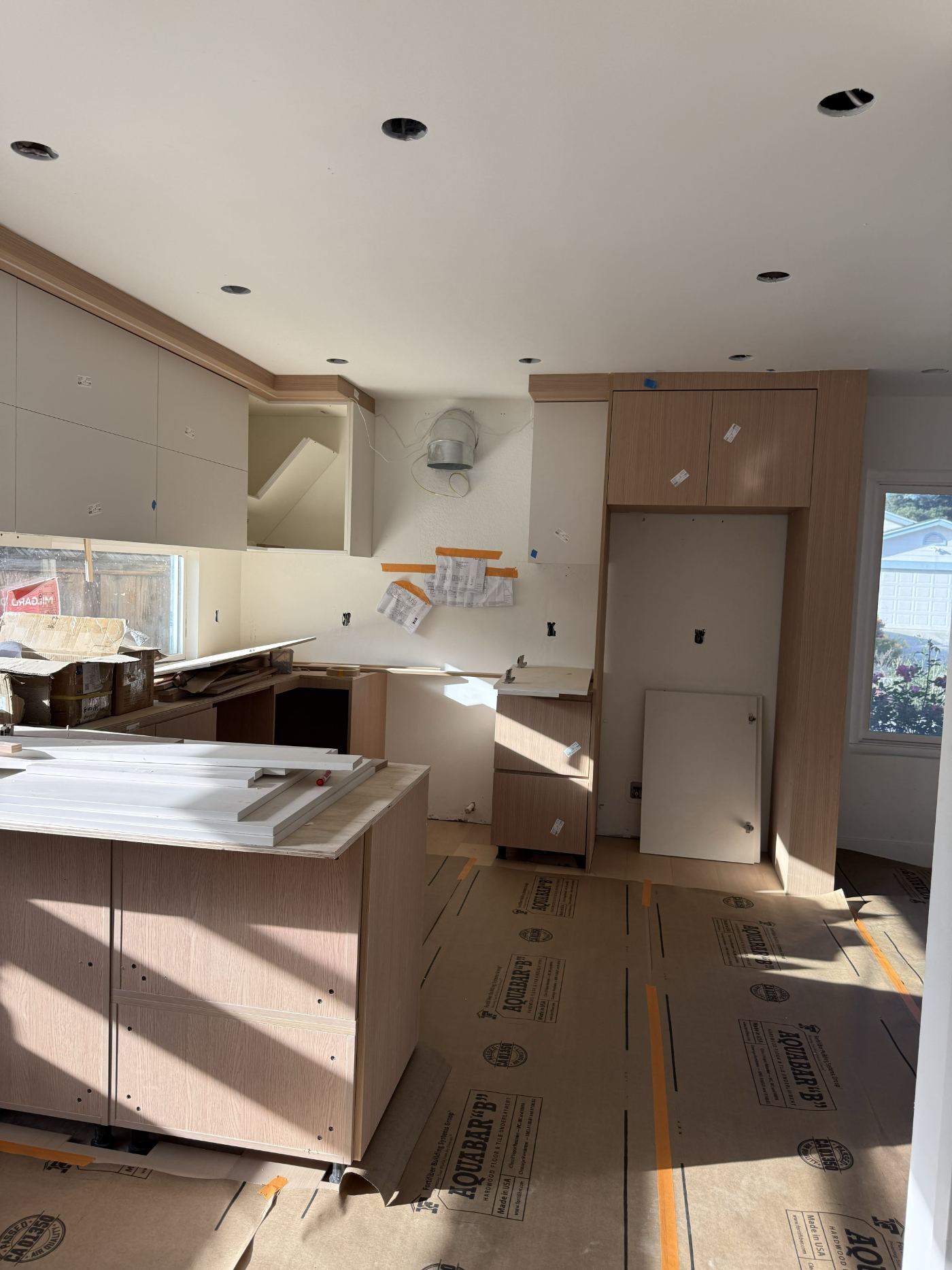 Pantry wall and appliance tower installed against the protected floor